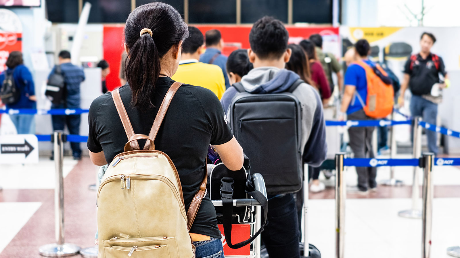 Passengers waiting in line at busy airport