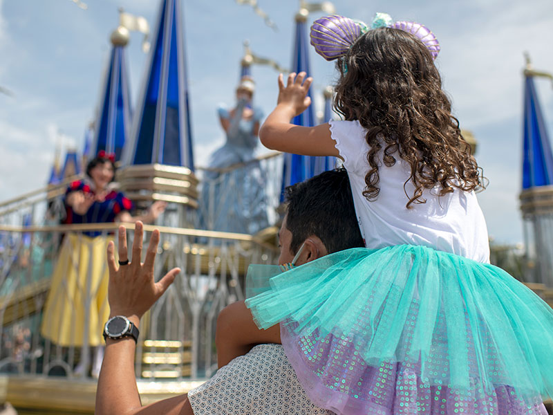 Father carrying daughter at Disney