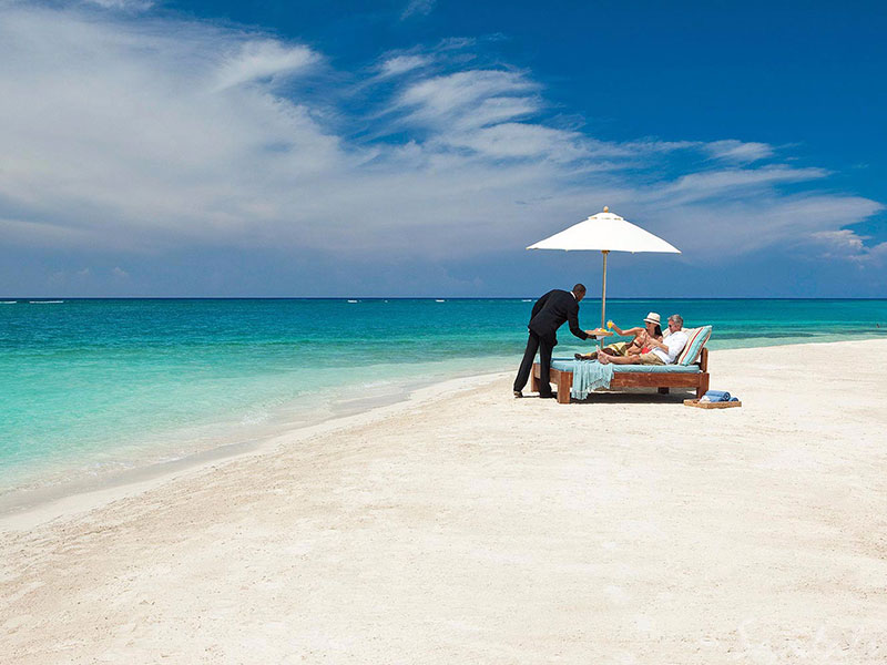 Couple being waited on while on beach